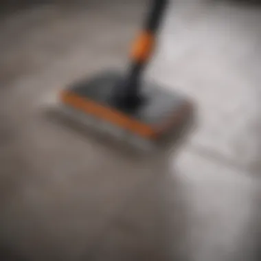 A close-up of a steam cleaner being used on tile flooring