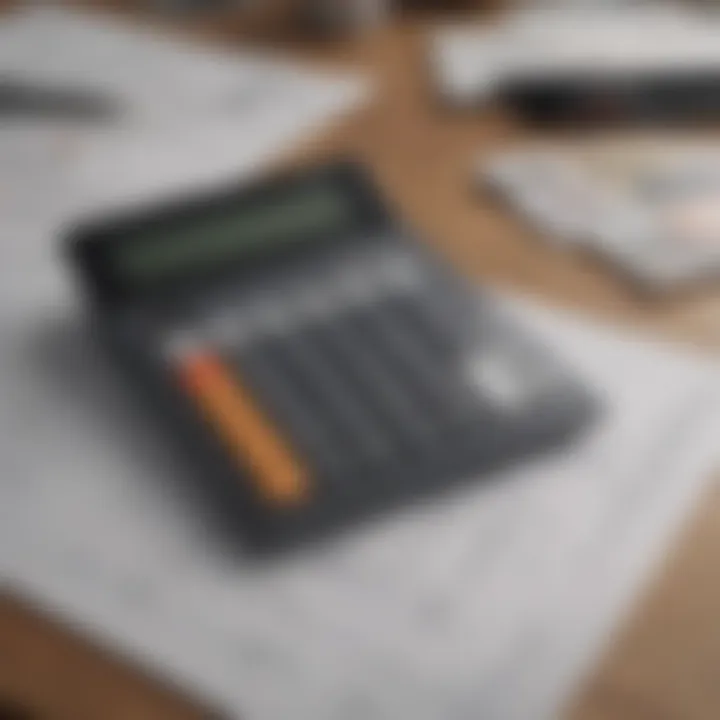 Calculator on a desk with house plans