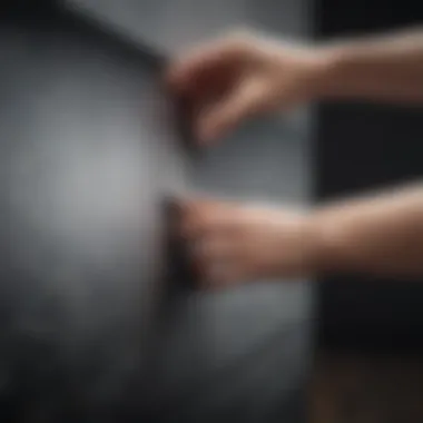 An individual gently wiping a TV screen with care