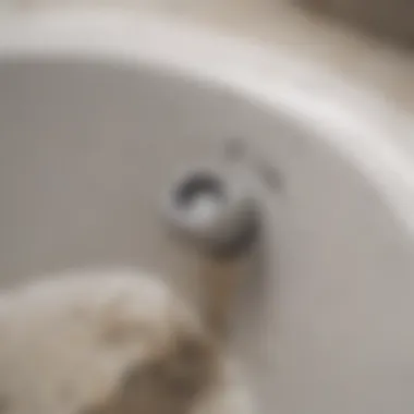 A close-up of a clogged bathtub drain with hair and debris