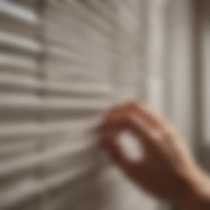 A person demonstrating a technique for cleaning mini blinds